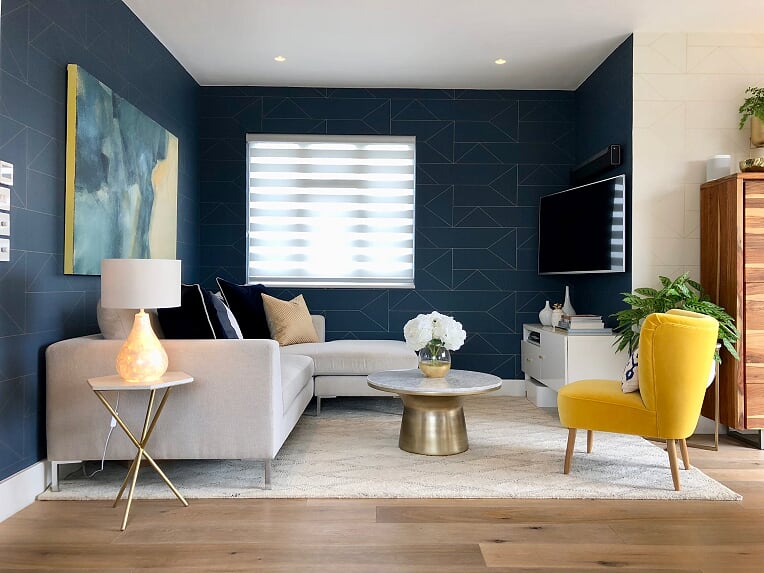 A blue & brass living & dining room with a geometric patterns and a pop ...