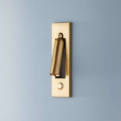 Niche wall light in an antique brass finish