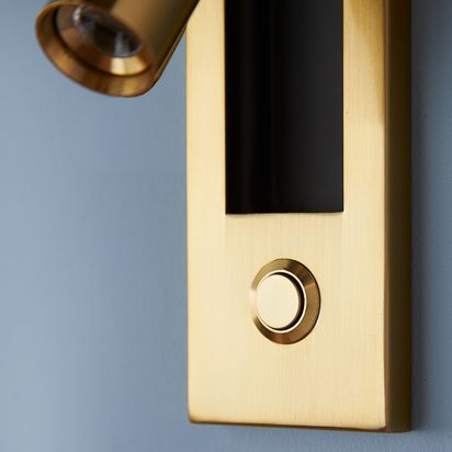 Niche wall light in an antique brass finish