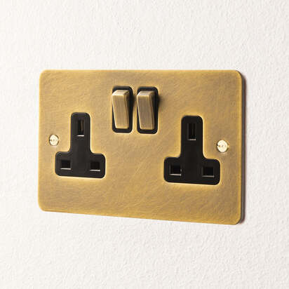 Lucian double socket with black inserts in aged brass